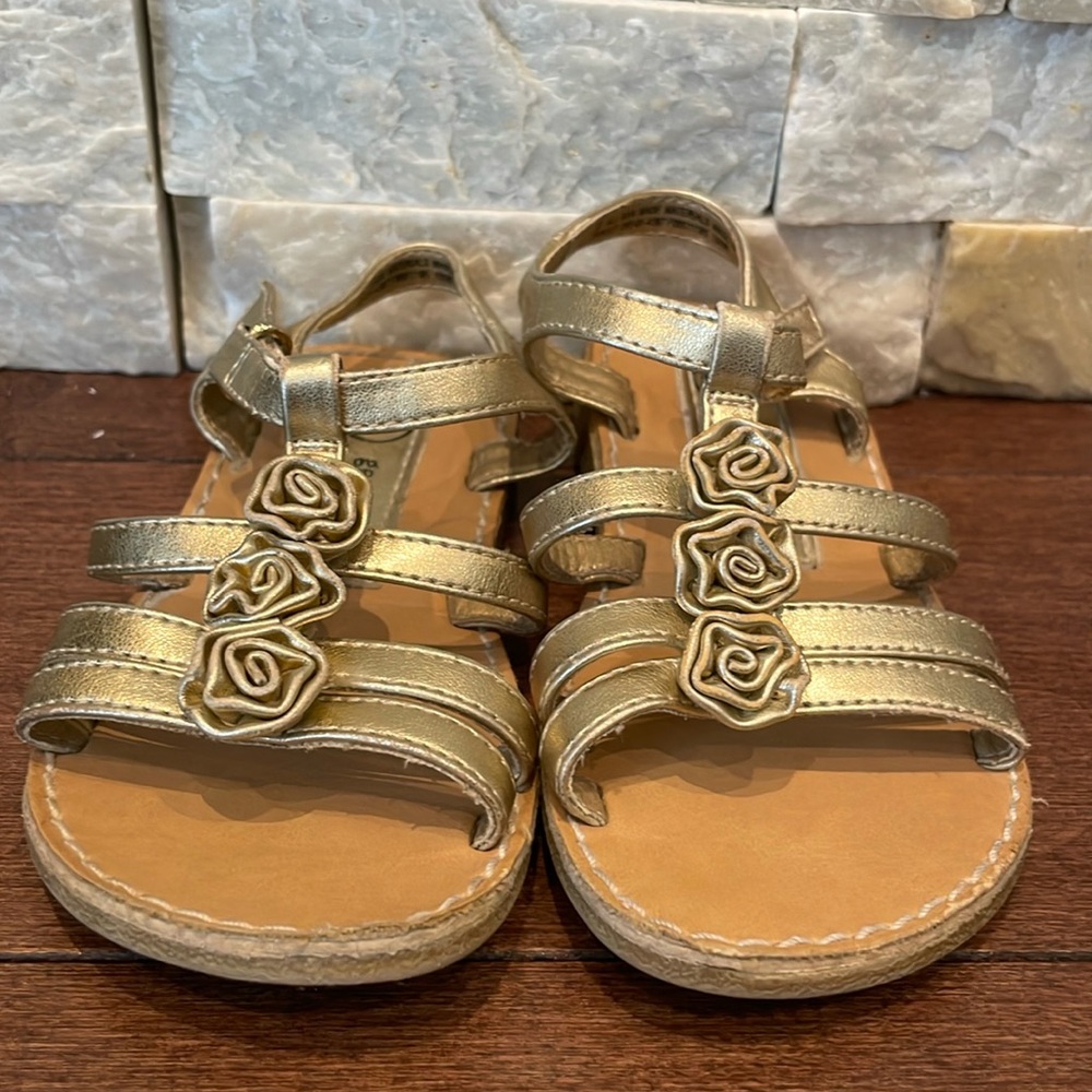 Gold strappy sandals with rosettes